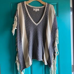 Cream and black patterned poncho.